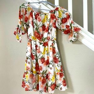 white sun dress with orange red and yellow flowers